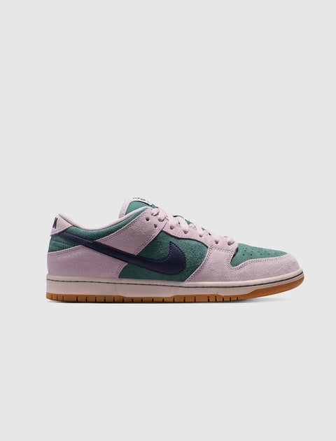 Low-top suede sneaker in pink, green, and navy with gum sole on white background