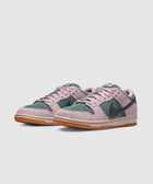 Pink and green suede low-top sneakers with gum soles on a white background