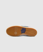 Gum rubber sole of a Nike SB Dunk Low sneaker on a light grey background