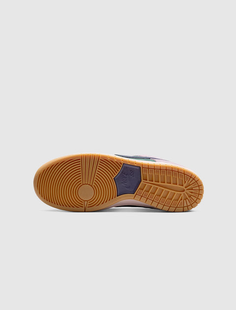 Gum rubber sole of a Nike SB Dunk Low sneaker on a light grey background