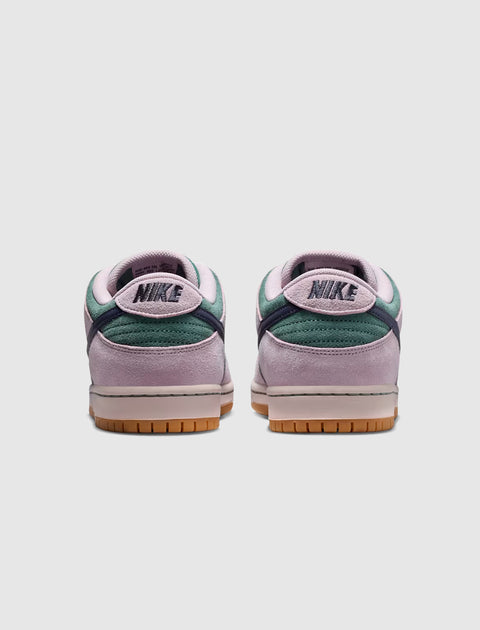 Back view of two-tone suede and leather low-top sneakers in green and lavender with gum soles