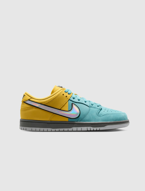 Yellow and teal low-top sneaker with iridescent Swoosh and grey sole on white background