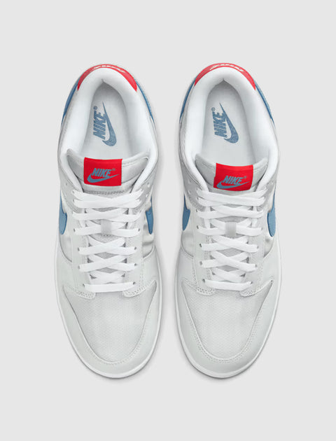White and blue low-top sneakers with red tongue tags and Nike branding, top view