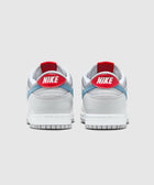 Back view of silver and white low-top sneakers with red heel tab and blue accents