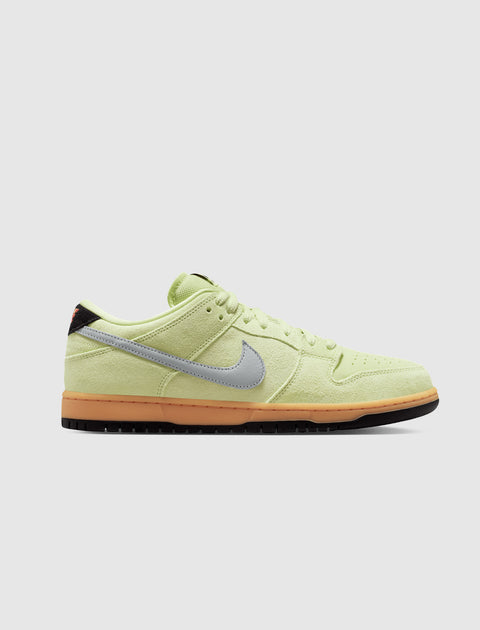 Side view of a light green suede low-top sneaker with grey swoosh and gum sole, men's streetwear