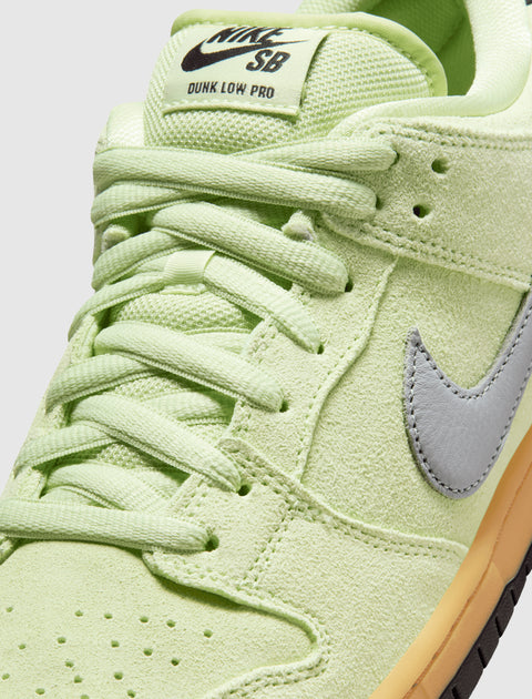 Close-up of Nike SB Dunk Low Pro sneaker in light green suede with gray Swoosh and gum sole