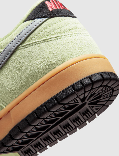 Closeup of sneaker heel with light green suede upper, gum midsole, and textured black outsole