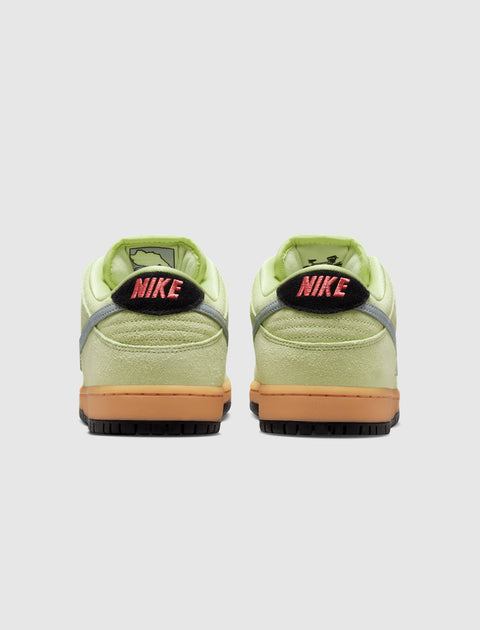 Back view of green Nike Dunk Low sneakers with gum soles and pink accent logo