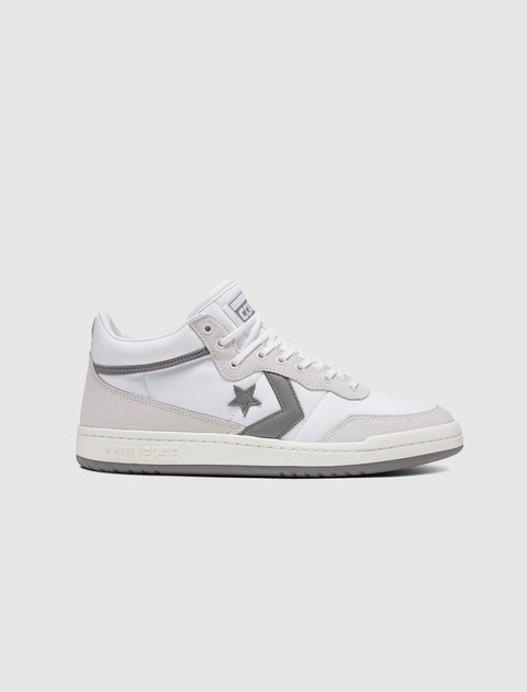 White and gray mid-top sneaker with star logo and suede overlays on a clean background