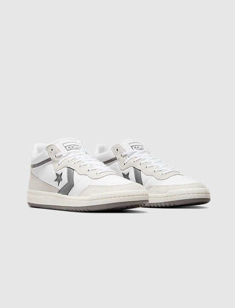 White and gray mid-top sneakers with star and chevron logo on side, streetwear style