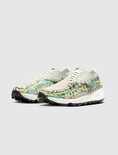 Men's woven low-top sneakers with multicolor accents and white midsoles on gray background