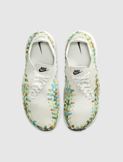 White woven sneakers with multicolor accents, top view, featuring Nike logo and laces.