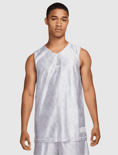 Man wearing a white patterned basketball jersey and matching shorts, front view