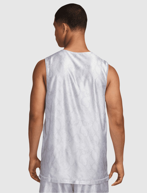 Man wearing white sleeveless snake print streetwear top and matching shorts, back view