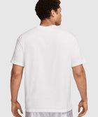 Man wearing plain white short sleeve t-shirt and light patterned shorts, back view