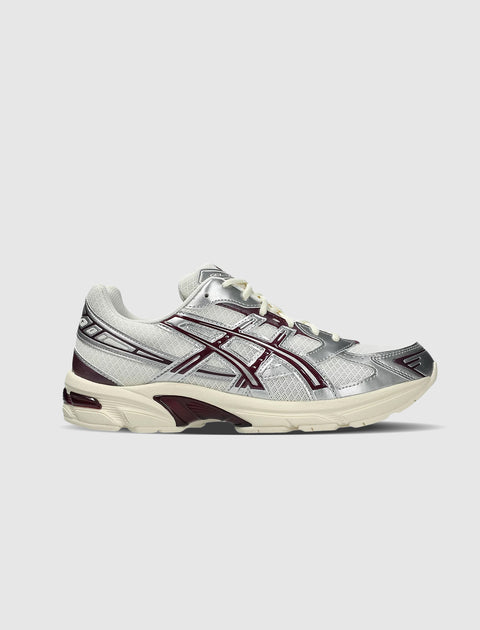 Cream and purple mesh and leather sneaker with silver accents on a white background