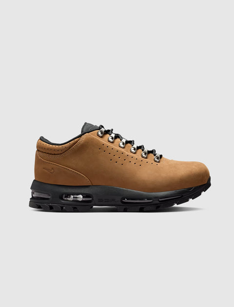 Low-top taupe sneaker with black sole, metal eyelets, and visible air cushioning, side view