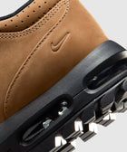 Close-up of tan leather sneaker heel with visible Air unit and treaded black sole