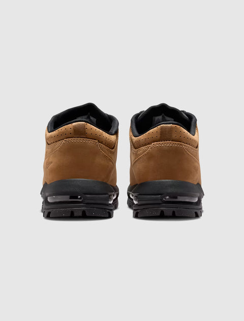 Rear view of brown and black men's streetwear sneakers with visible air cushioning