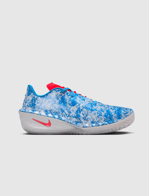 Blue and white marbled low-top sneaker with red accents and Nike logo on a neutral background