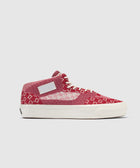 Red and white knit mid-top sneaker with white sole and laces, side profile view