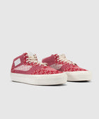 Red and white knit mid-top sneakers with cream soles and white laces on a plain background