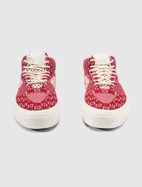Front view of red and white knit high-top sneakers with white laces and rubber soles