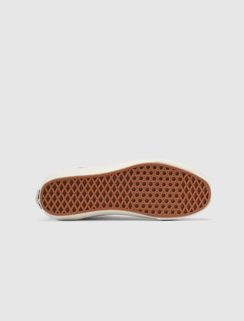 Closeup of brown waffle sole on low-top skate sneaker, isolated on white background