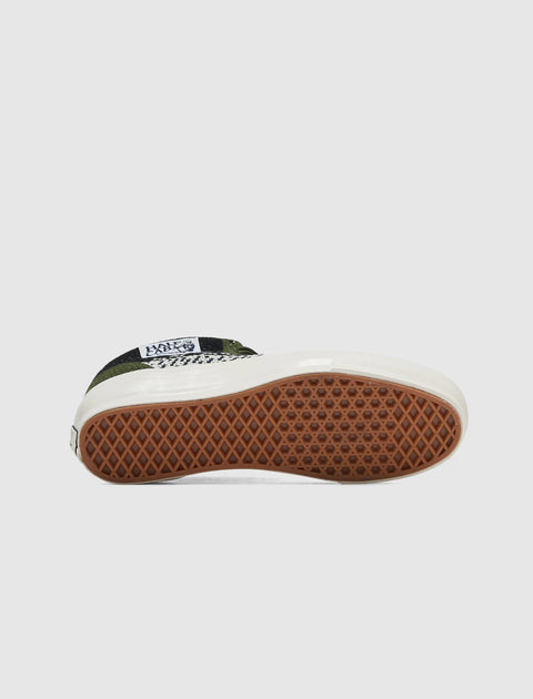Streetwear sneaker with gum waffle outsole, checkered pattern, and white midsole
