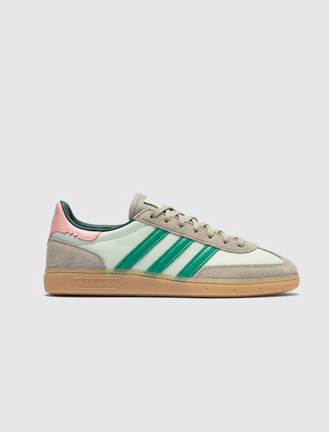 Mint green and beige sneaker with green stripes, pink heel accent, and gum sole on white background