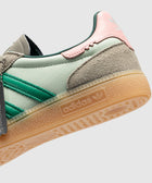 Mint green and pink Adidas sneaker with suede accents and gum sole, close-up side view