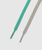 Mint green and beige sneaker laces on white background, close-up detail