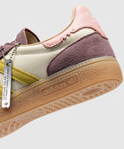 Adidas sneaker with pastel purple, yellow, and pink accents and gum sole close-up