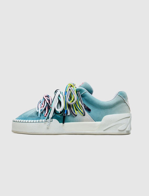 Side view of a grey, blue, and pink sneaker with multicolored laces on a white background