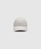 Beige Nike SB baseball cap with white embroidered logo, streetwear accessory