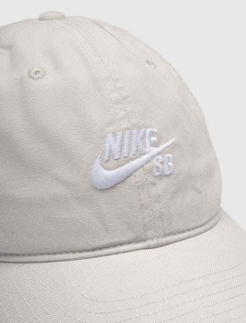 Beige cotton baseball cap with embroidered white Nike SB logo on front