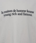 White streetwear t-shirt with black text 'la maison de homme femme young rich and famous' printed on front.