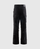 Men's black distressed streetwear jeans with frayed patchwork on a plain background