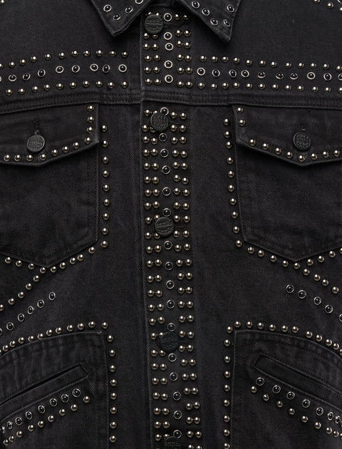 Black denim jacket with metal stud detailing and front flap pockets, streetwear style