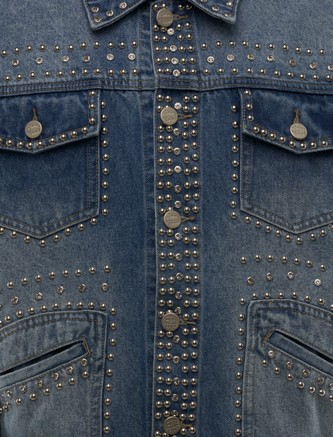 Close-up of blue denim jacket with silver studs and decorative metal buttons