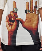 White streetwear T-shirt with graphic print of hands wearing multiple sports rings