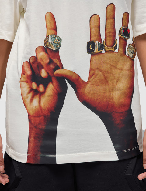 White streetwear T-shirt with graphic print of hands wearing multiple sports rings