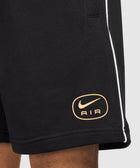 Black men's streetwear shorts with gold Nike Air logo and white piping detail