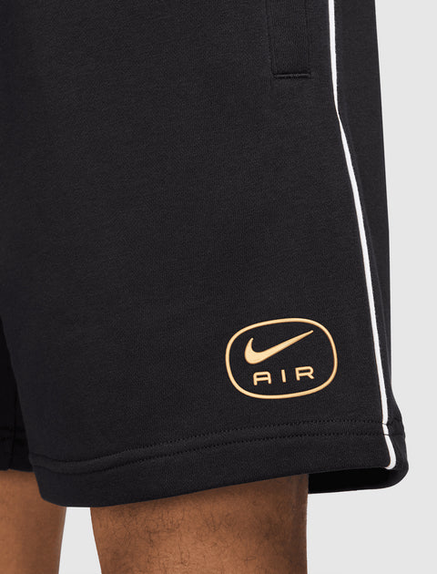 Black men's streetwear shorts with gold Nike Air logo and white piping detail