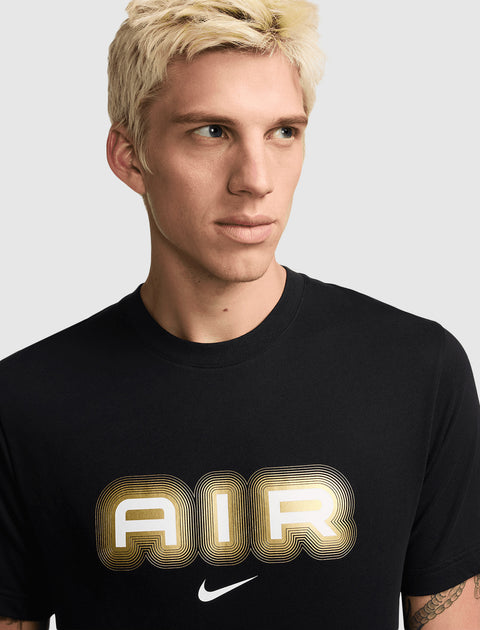 Man wearing black t-shirt with metallic gold and white AIR graphic and Nike logo