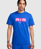 Man wearing blue t-shirt with pink AIR graphic and Nike logo, blue shorts, neutral background