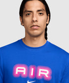 Man wearing blue Nike t-shirt with bold pink AIR graphic on chest
