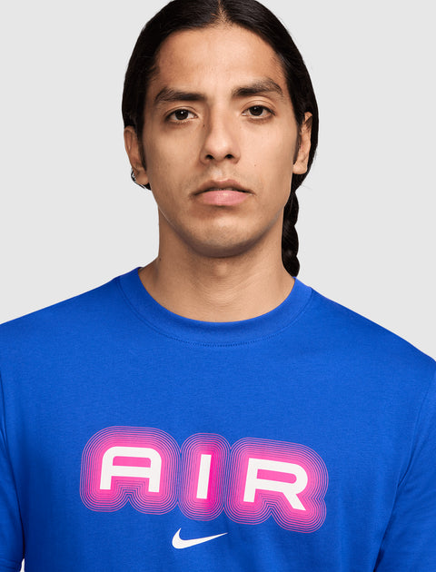 Man wearing blue Nike t-shirt with bold pink AIR graphic on chest