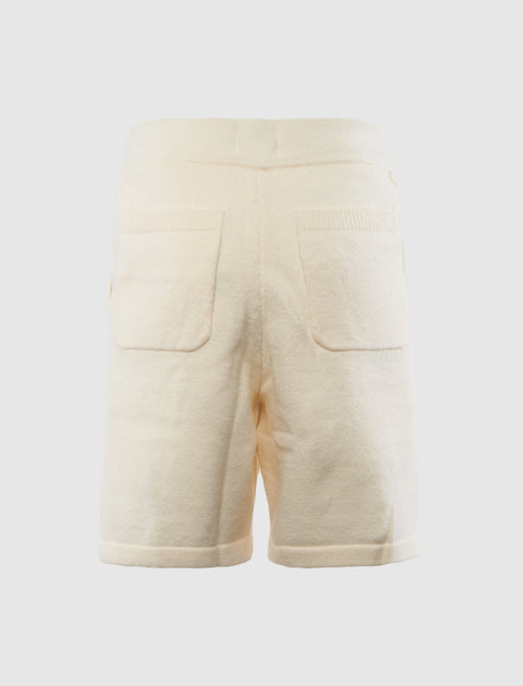 Back view of cream fleece men's streetwear shorts with two rear pockets