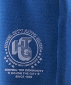 Close-up of blue fabric with Inner City Auto Club graphic and Honor The Gift text.